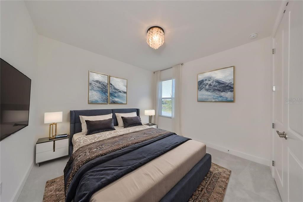 933 Signet Drive Apollo Beach, FL 33572 - Photo 36 of 66 a bedroom with a bed and a flat screen tv