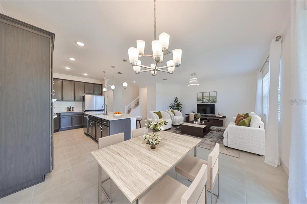 933 Signet Drive Apollo Beach, FL 33572 - Photo 5 of 66 a view of a dining room with furniture and a chandelier
