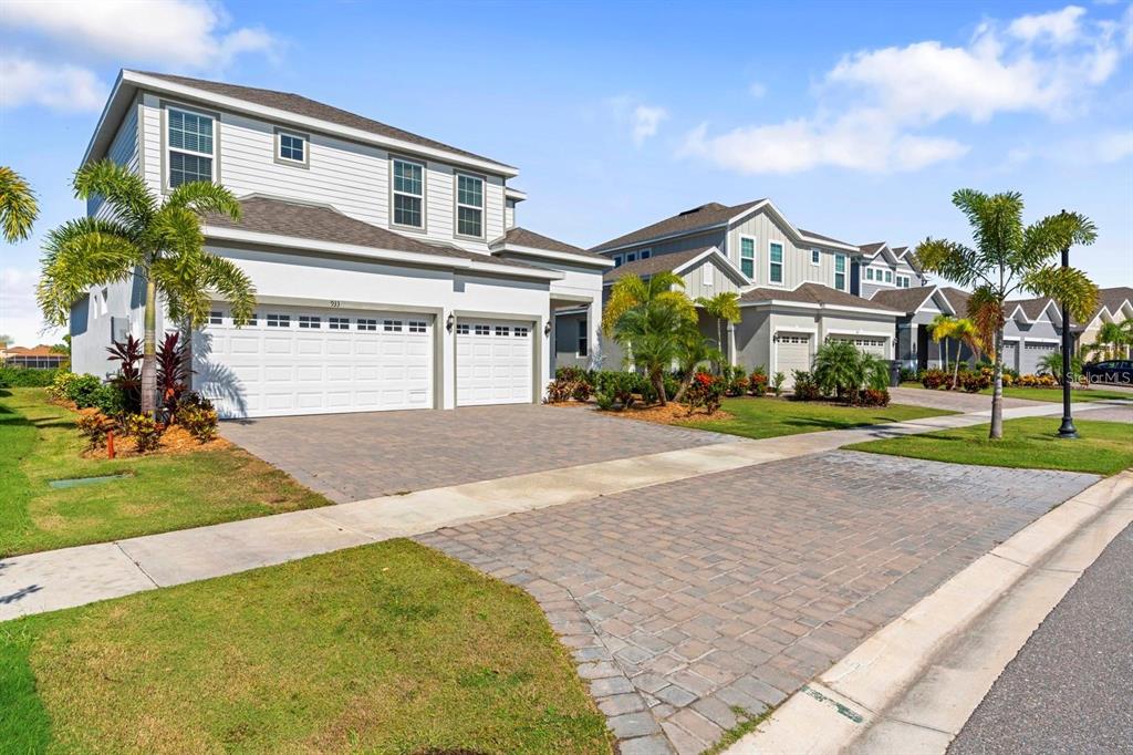 933 Signet Drive Apollo Beach, FL 33572 - Photo 51 of 66 a front view of a house with a yard and garage