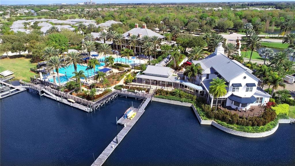 933 Signet Drive Apollo Beach, FL 33572 - Photo 65 of 66 an aerial view of a house with a garden and lake view