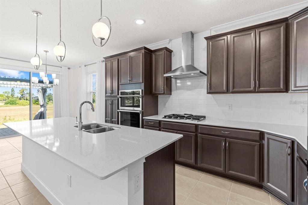 933 Signet Drive Apollo Beach, FL 33572 - Photo 8 of 66 a kitchen with stainless steel appliances granite countertop a sink a stove and a refrigerator