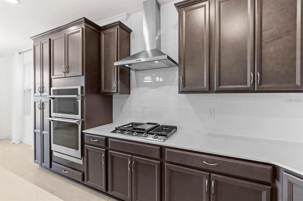 933 Signet Drive Apollo Beach, FL 33572 - Photo 9 of 66 a kitchen with stainless steel appliances granite countertop a refrigerator and a stove