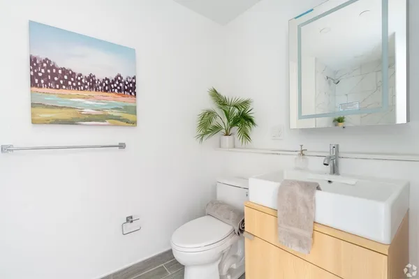 a white toilet sitting next to a bathroom sink