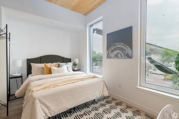 a bedroom with a bed and a window