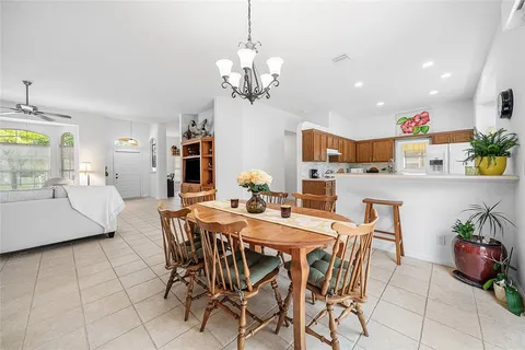 a view of a dining room with furniture and chandelier