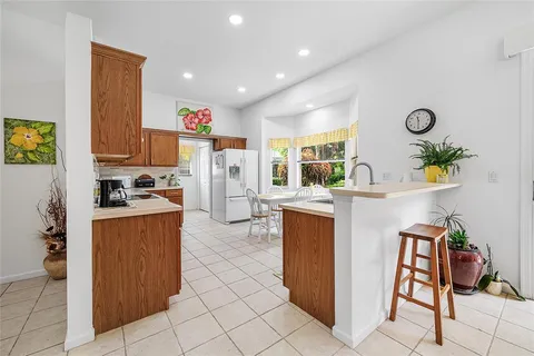 a kitchen with refrigerator and cabinets