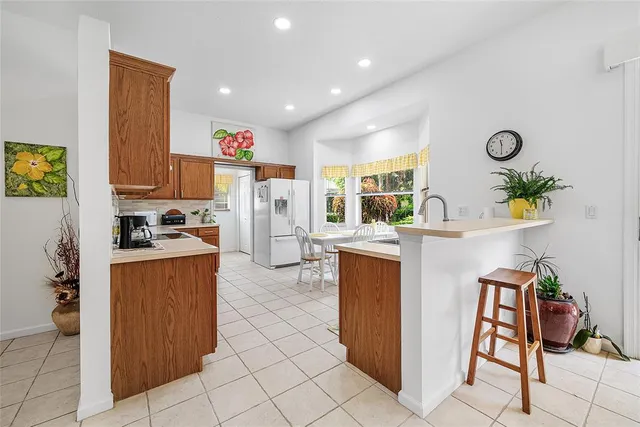 a kitchen with refrigerator and cabinets