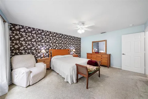 a bedroom with a bed and lamp