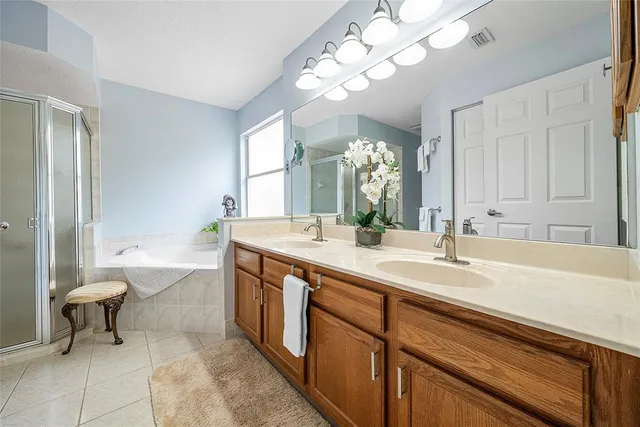a spacious bathroom with a granite countertop sink a toilet and a mirror
