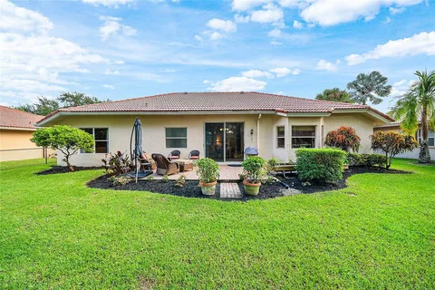 a view of a house with backyard porch and sitting area