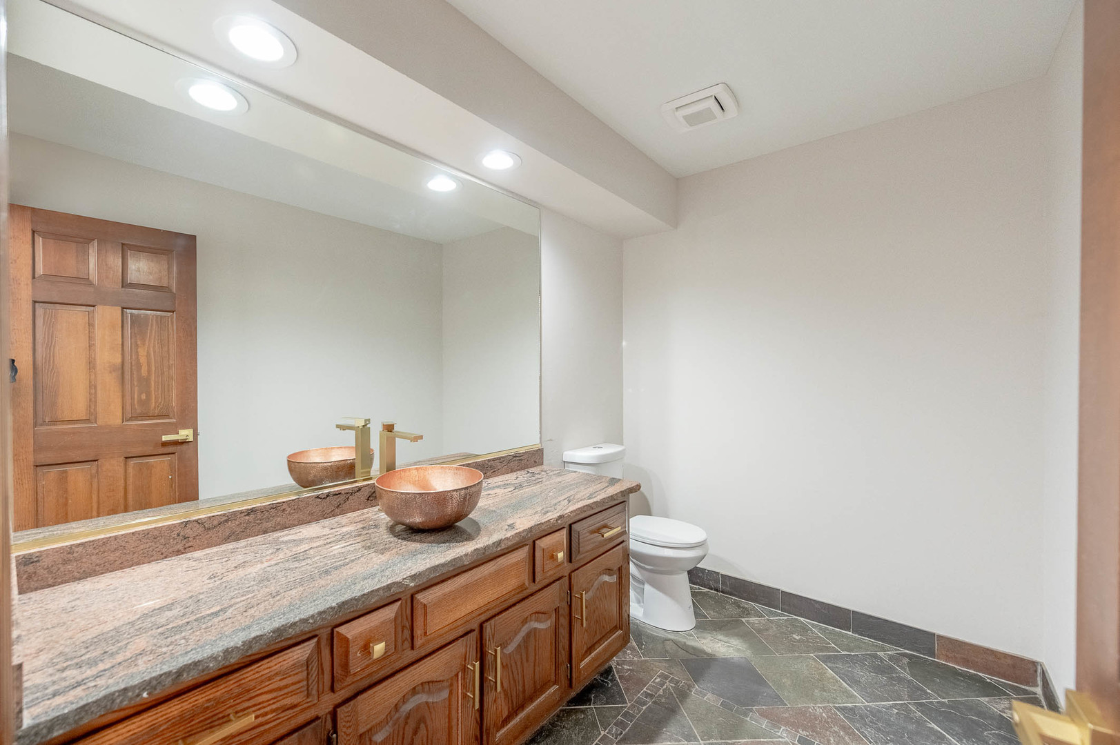 501 Bryan Trail New Lenox, IL 60451 - Photo 19 of 24 a bathroom with a granite countertop sink a toilet and a window