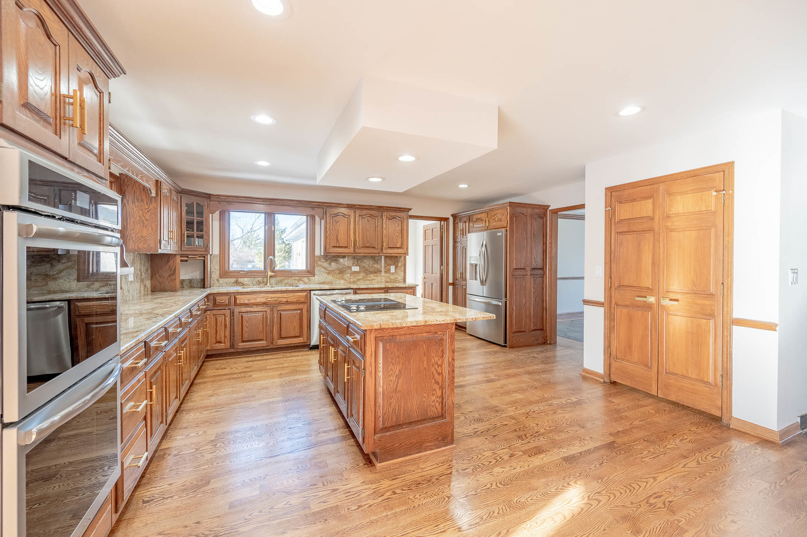 501 Bryan Trail New Lenox, IL 60451 - Photo 7 of 24 a large kitchen with stainless steel appliances granite countertop a large counter top a stove and a refrigerator