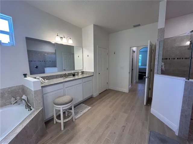 a kitchen with a sink cabinets and wooden floor