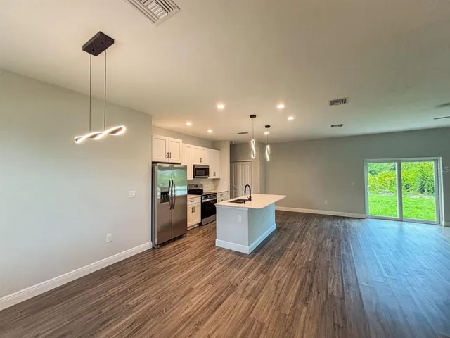 a view of a kitchen with a sink and microwave