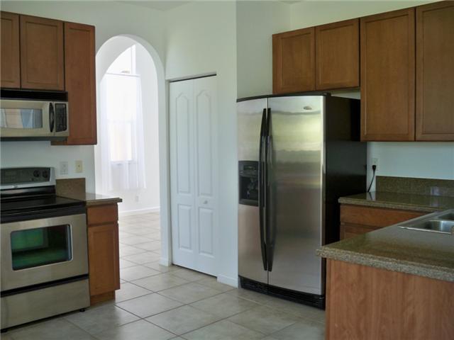 5565 Spanish River Road Fort Pierce, FL 34951 - Photo 2 of 12 a kitchen with metallic refrigerator freezer and a dishwasher