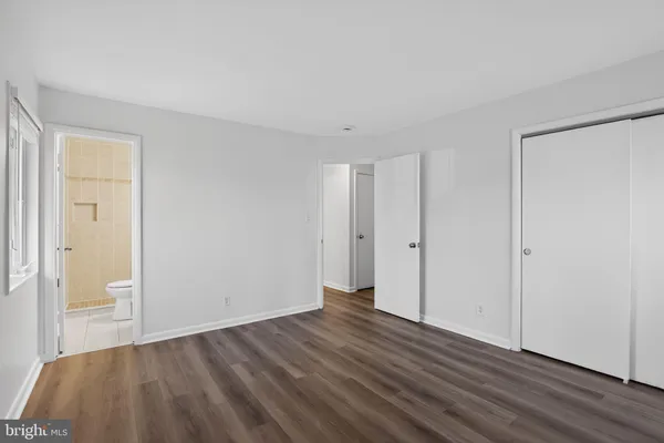a view of a room with wooden floor and a window