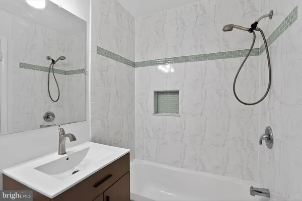 a bathroom with a sink a mirror and a shower