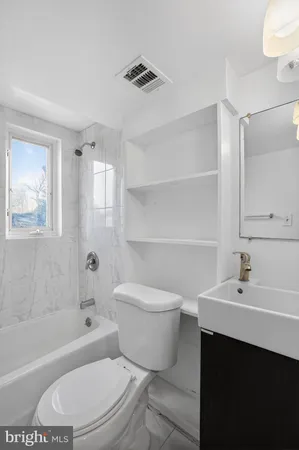 a bathroom with a sink a toilet and a bathtub