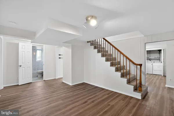a view of entryway and hall with wooden floor