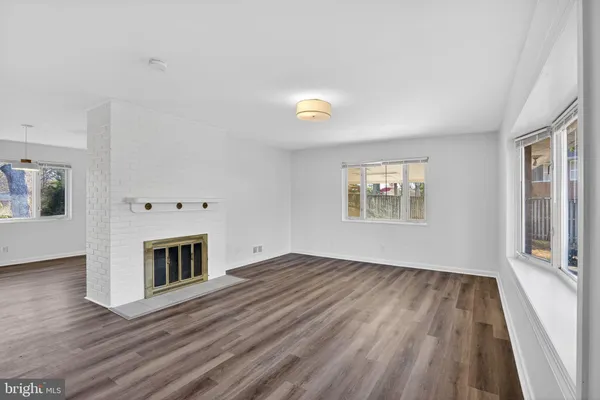 a view of main area fire place window and wooden floor