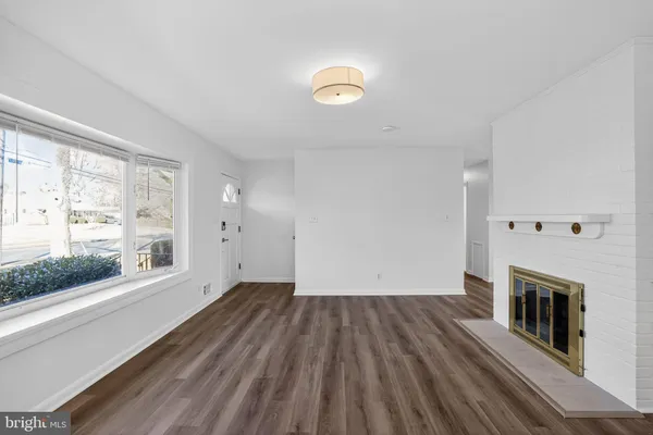 wooden floor in an empty room with a fireplace
