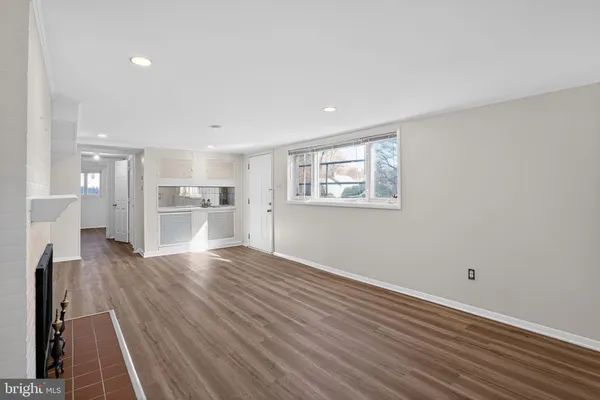 a view of a kitchen with wooden floor and windows