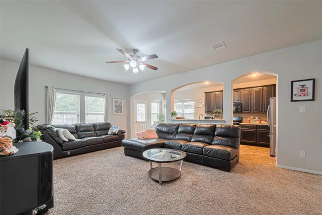 a living room with furniture and a large window