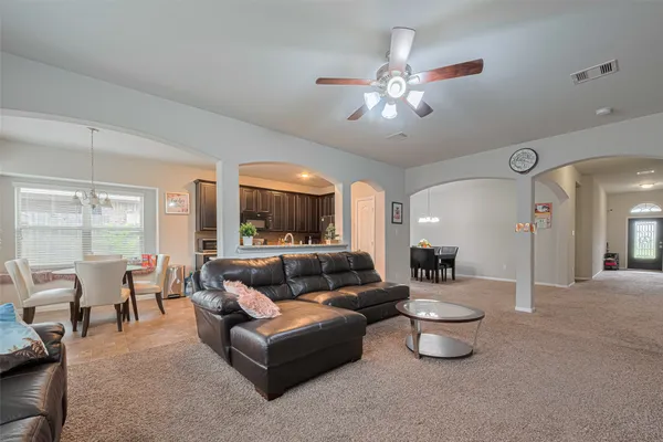 a living room with furniture and a chandelier