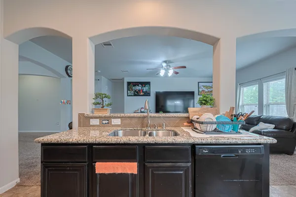 a view of living room with granite countertop furniture a fireplace and wooden floor