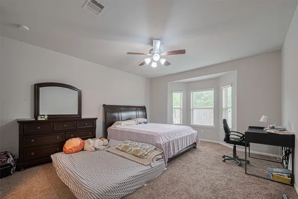 a bedroom with a bed and a dresser