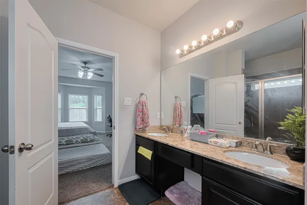 a bathroom with a sink double vanity and a mirror