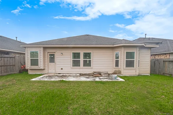 a front view of house with a garden and patio