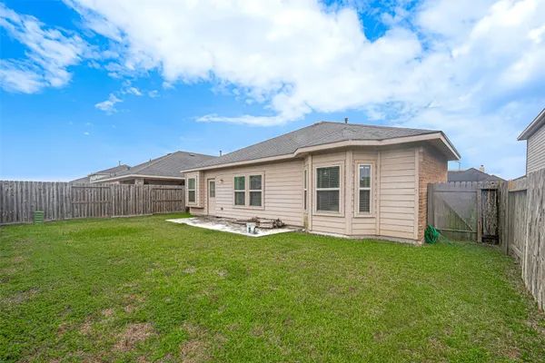 a view of a house with a yard and sitting area