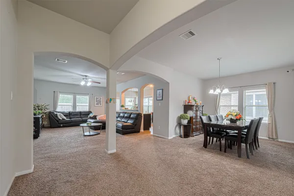 a view of a livingroom with furniture and a large window