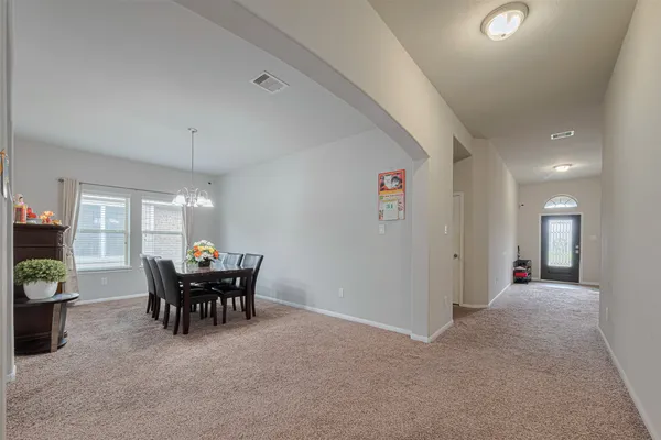 a view of a dining room with furniture and chandelier