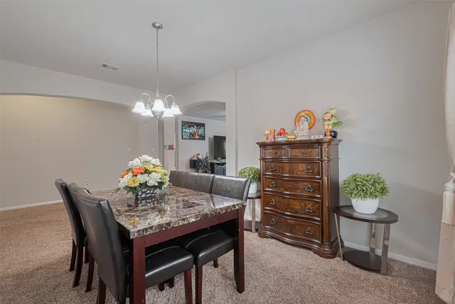 a view of a dining room and a table and chairs