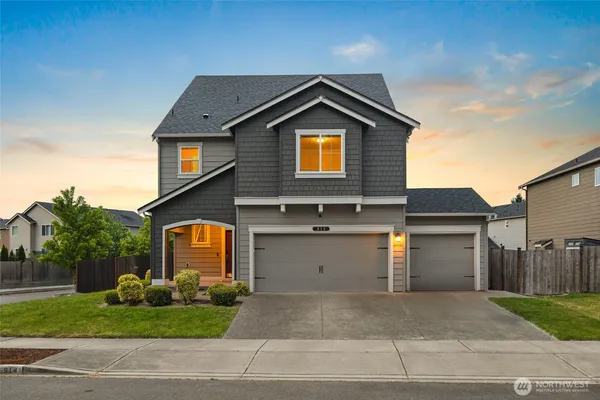 a front view of a house with a yard and garage