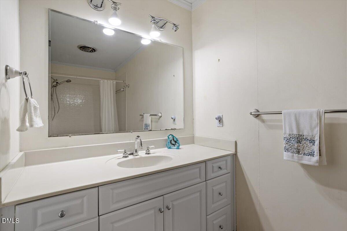 3107 Dixon Road Durham, NC 27707 - Photo 25 of 35 a bathroom with a sink double vanity and a mirror