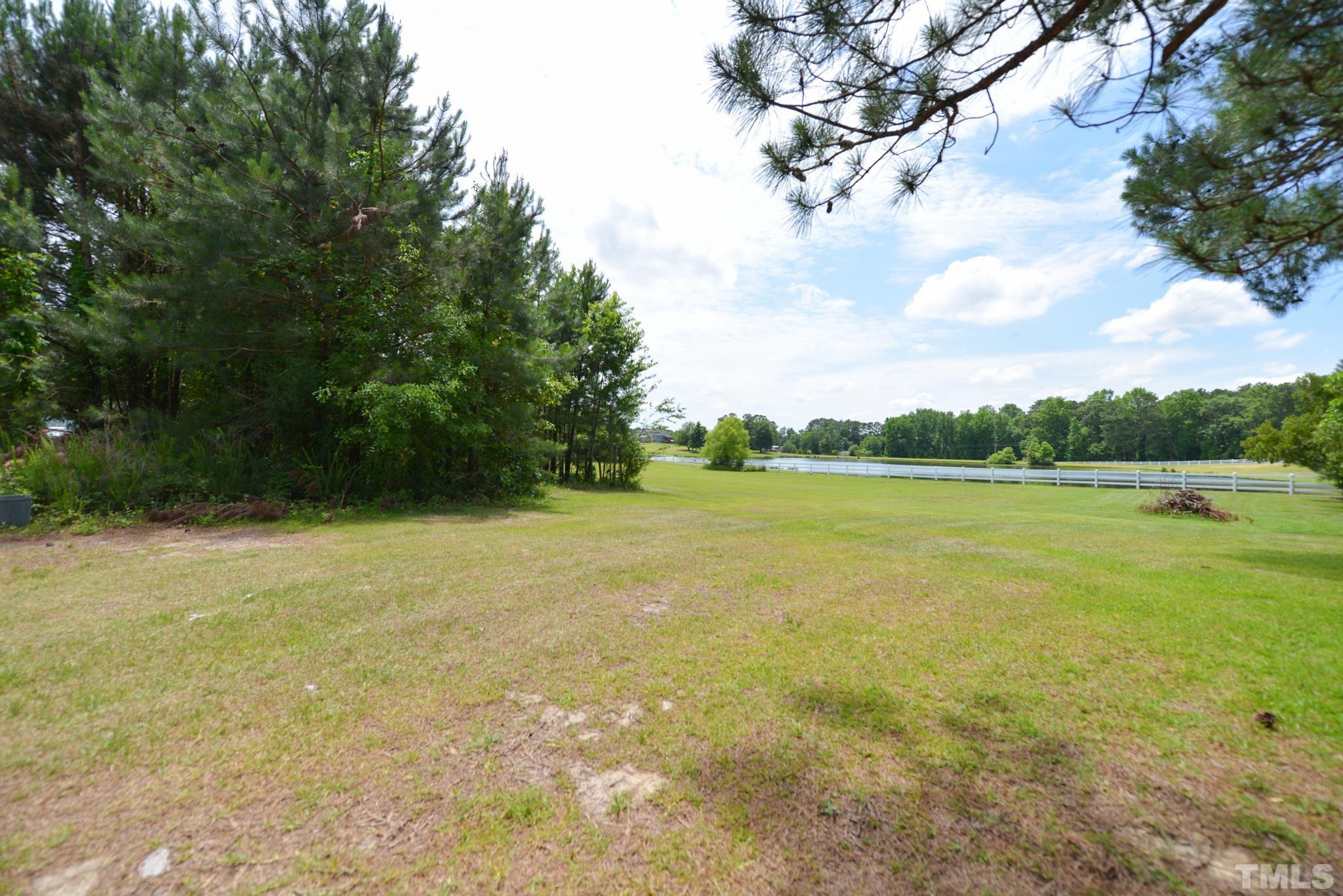 6337 B Zacks Mill Road Angier, NC 27501 - Photo 2 of 7 a view of a lake view with a big yard