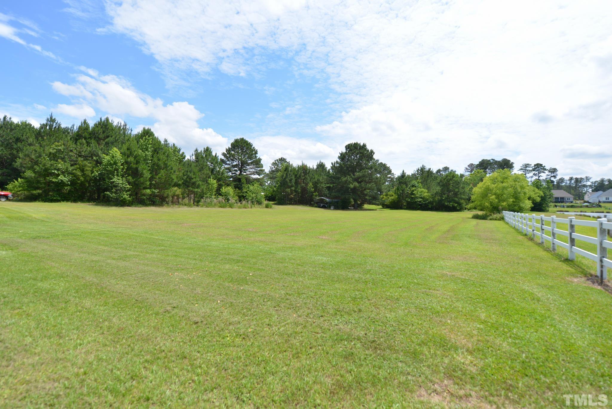 6337 B Zacks Mill Road Angier, NC 27501 - Photo 3 of 7 a view of a green field with wooden fence