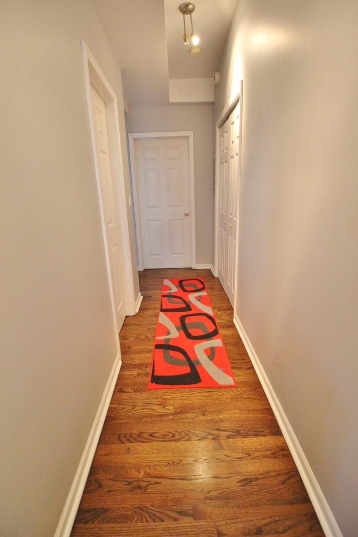 3339 South Giles Avenue Chicago, IL 60616 - Photo 13 of 38 a bedroom with a bed and wooden floor