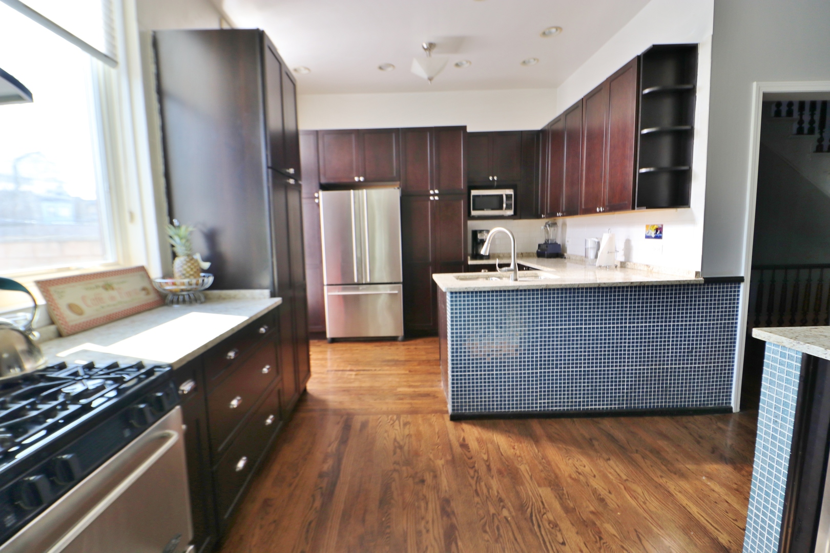 3339 South Giles Avenue Chicago, IL 60616 - Photo 18 of 38 a kitchen with kitchen island granite countertop a sink stove and refrigerator