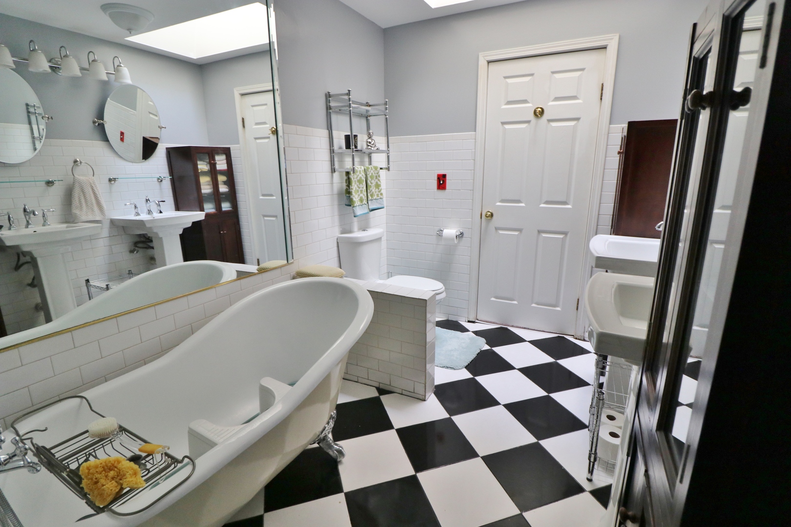 3339 South Giles Avenue Chicago, IL 60616 - Photo 28 of 38 a living room with a black white checkered floor with a dining table and a mirror