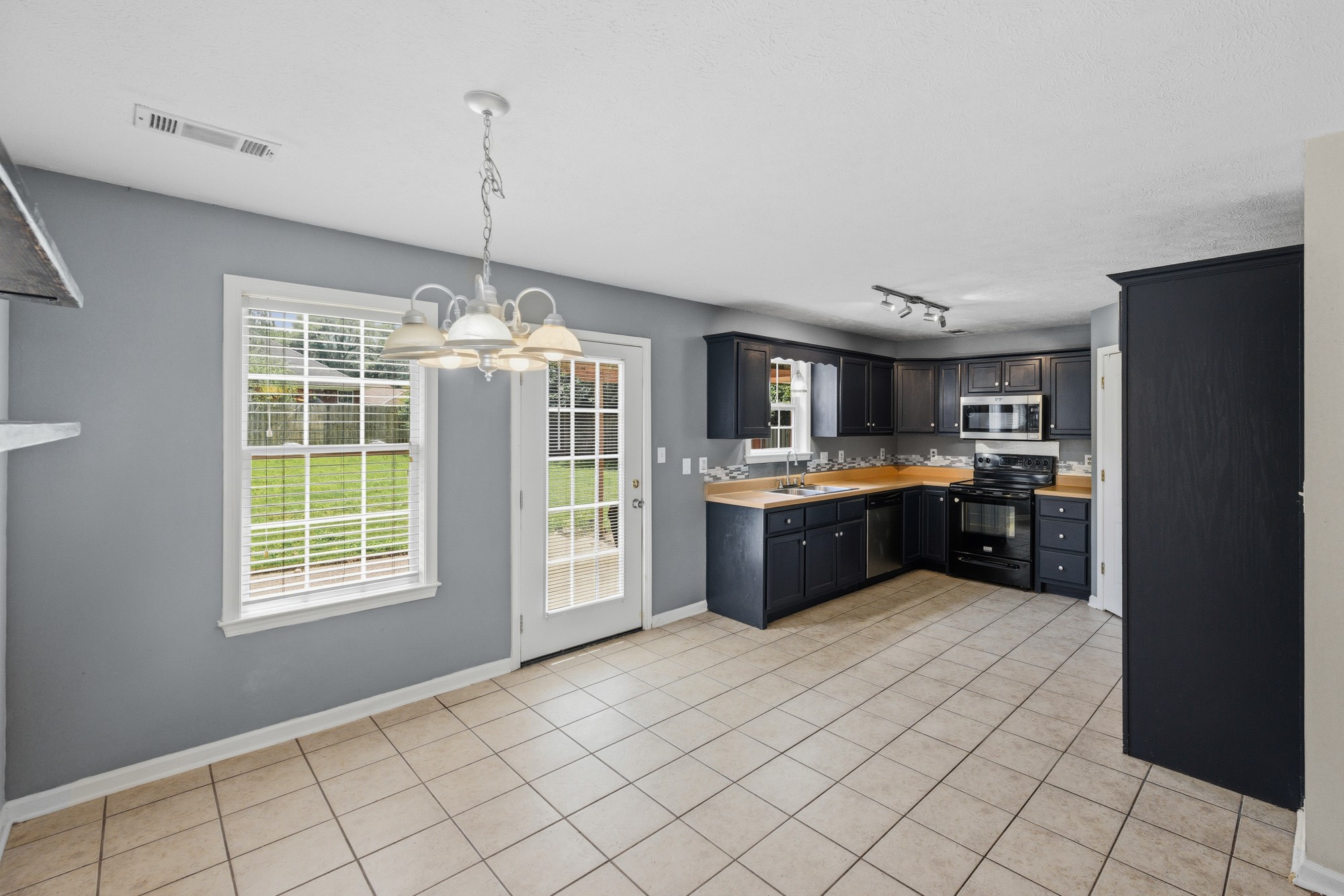 270 Reed Circle Medina, TN 38355 - Photo 16 of 30 a kitchen with stainless steel appliances kitchen island granite countertop a refrigerator and a sink