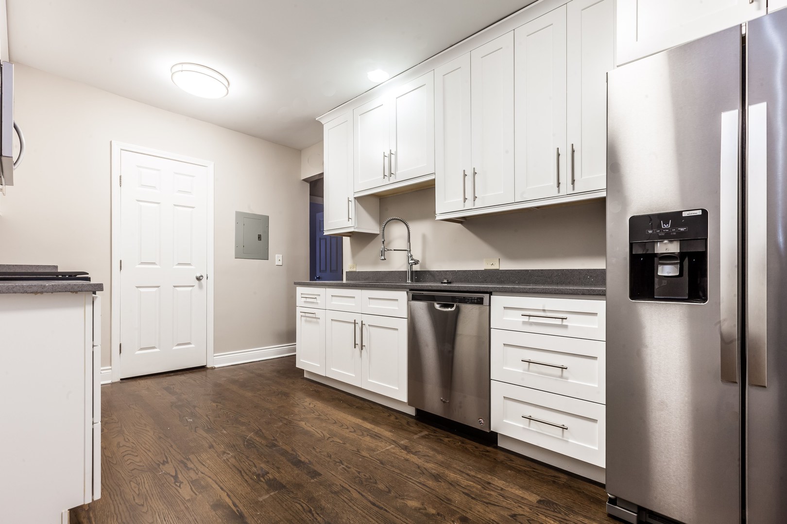 4529.5 South Drexel Boulevard, Unit 2W Chicago, IL 60653 - Photo 5 of 11 a kitchen with stainless steel appliances a refrigerator and cabinets