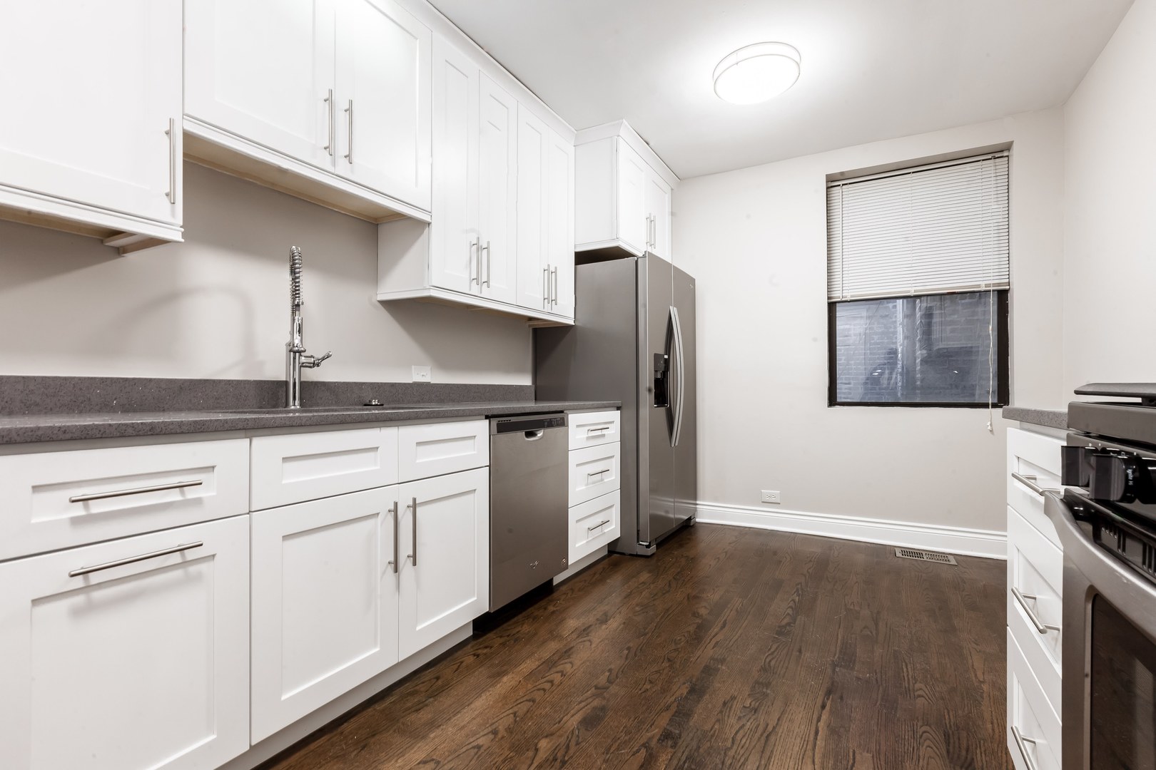 4529.5 South Drexel Boulevard, Unit 2W Chicago, IL 60653 - Photo 7 of 11 a kitchen with stainless steel appliances granite countertop a refrigerator and a stove
