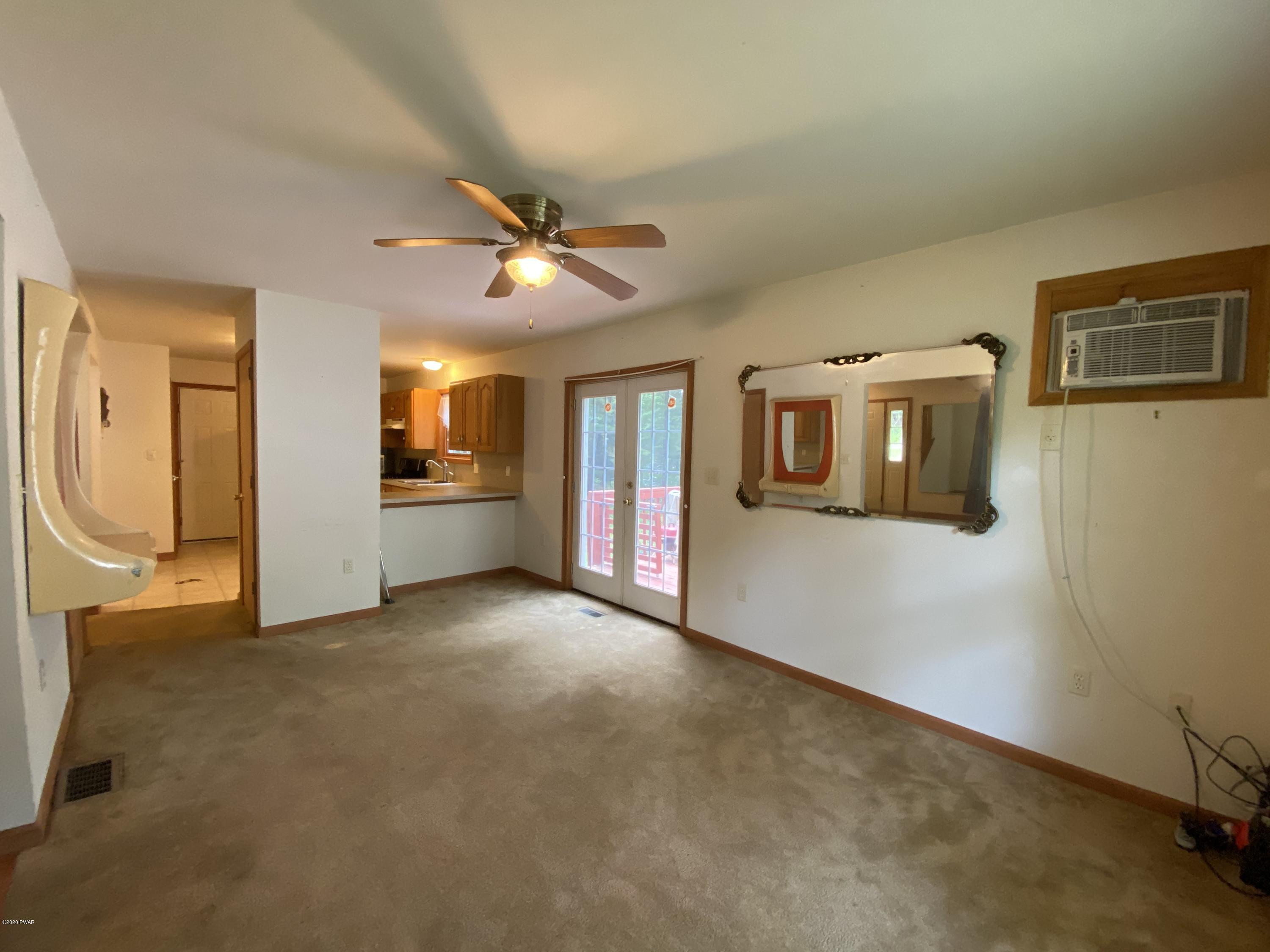 111 Beecher Road Dingmans Ferry, PA 18328 - Photo 9 of 25 a view of a big room with wooden floor and windows