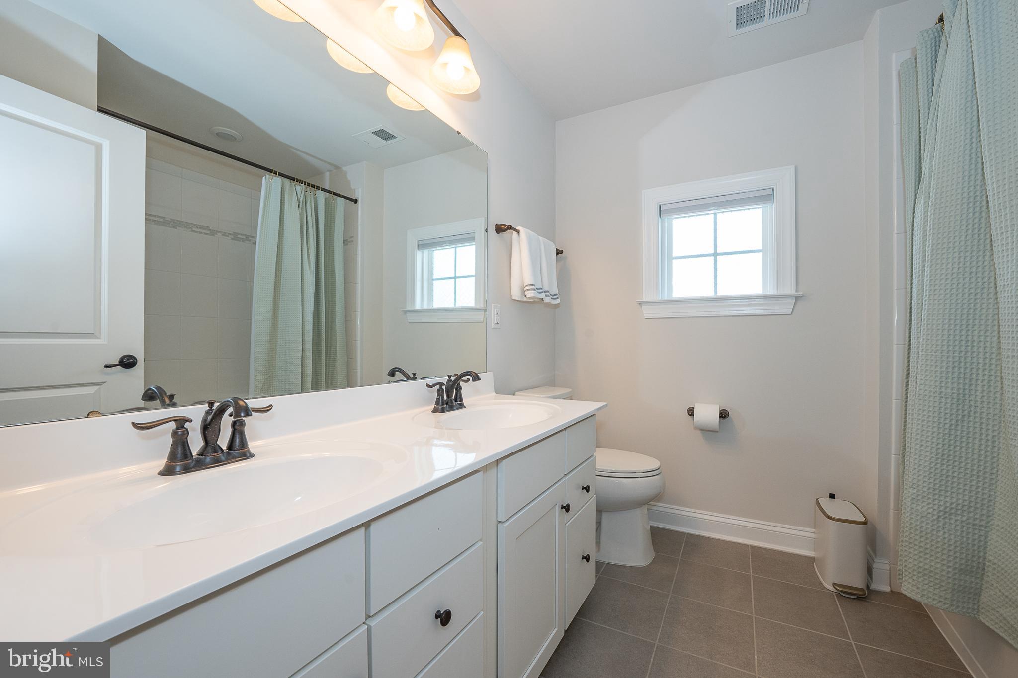 500 Quarry Point Road Malvern, PA 19355 - Photo 25 of 45 a bathroom with a sink a toilet and a mirror