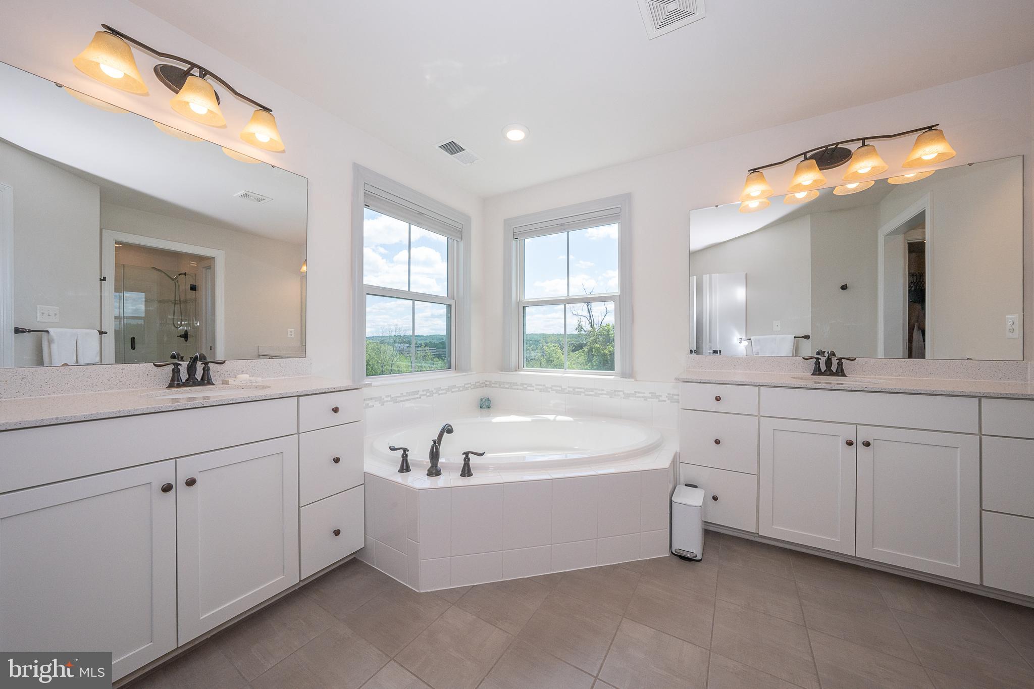 500 Quarry Point Road Malvern, PA 19355 - Photo 34 of 45 a spacious bathroom with a tub a double vanity sink and mirror