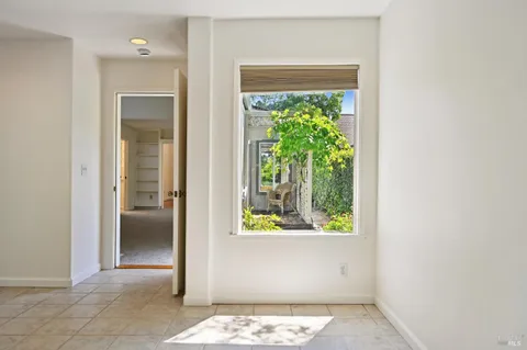 a view of a livingroom with a fireplace and window